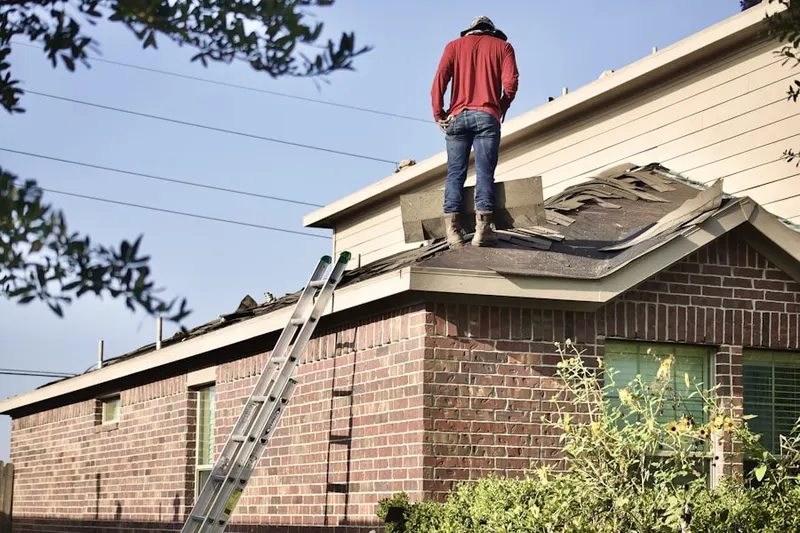 Professional roofer working on a residential roof in De Leon Springs